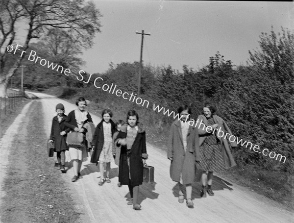 SCHOOL GIRLS POSE ON COUNTRY ROAD